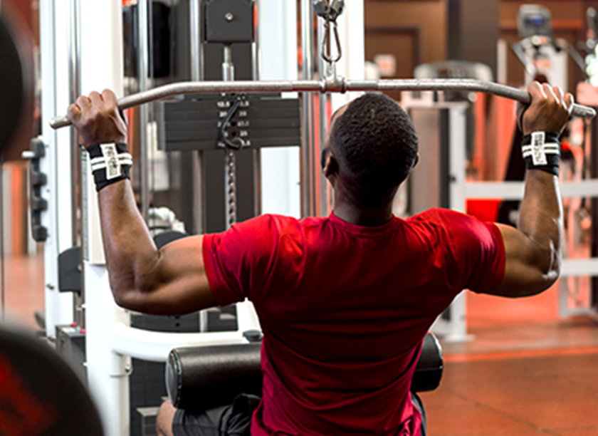 Man working out on a lateral pull down machine at GoodLife